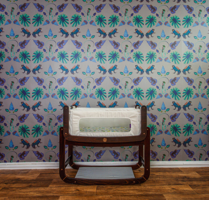 A room with patterned frog wallpaper, with the frogs sitting on brightly coloured leaves in a vivid illustration